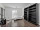 Bedroom with dark bookcase, desk, wood-look floors, and natural light from the window at 1303 Highland Bluff Se Dr # 303, Atlanta, GA 30339