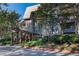 Elegant condo building with stone facade and covered entrance, surrounded by mature trees and landscaping at 1303 Highland Bluff Se Dr # 303, Atlanta, GA 30339