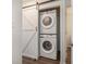 Laundry area with stacked washer and dryer, maximizing space with a barn-style door at 1303 Highland Bluff Se Dr # 303, Atlanta, GA 30339