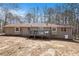 Back exterior of the home showing a deck with a seating area and neutral siding at 30 Apache Ct, Locust Grove, GA 30248