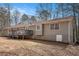 The back exterior of the home features a deck and neutral siding at 30 Apache Ct, Locust Grove, GA 30248