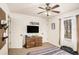 Comfortable bedroom featuring a ceiling fan, a dresser, and a window, providing ample storage at 30 Apache Ct, Locust Grove, GA 30248