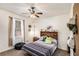 Cozy bedroom with ceiling fan, neutral walls, a comfortable bed, and a window for natural light at 30 Apache Ct, Locust Grove, GA 30248