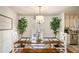 Cozy dining room features wood table, bench seating, overhead lighting, and decorative plants near a door to the outside at 30 Apache Ct, Locust Grove, GA 30248