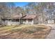 Charming home with front porch, stone accents, shutters, and detached garage on a large lot at 30 Apache Ct, Locust Grove, GA 30248