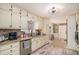 Bright kitchen featuring granite countertops, stainless steel appliances, stylish lighting, and access to a breakfast nook at 30 Apache Ct, Locust Grove, GA 30248