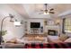 Cozy living room features a fireplace, ceiling fan and hardwood floors at 30 Apache Ct, Locust Grove, GA 30248
