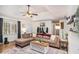 Comfortable living room offers a ceiling fan, hardwood floors and ample seating at 30 Apache Ct, Locust Grove, GA 30248