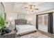 Serene main bedroom showcasing tray ceiling, soft carpet, natural light, and calming decor at 30 Apache Ct, Locust Grove, GA 30248