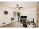 Bright office space with dual monitors, a ceiling fan, and a large window overlooking a treed backyard at 30 Apache Ct, Locust Grove, GA 30248