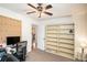 Spacious home office area with a large bookshelf, pegboard, and natural light from the exterior at 30 Apache Ct, Locust Grove, GA 30248
