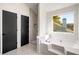 Bathroom featuring a soaking tub and separate walk-in shower with neutral stone tile at 5541 Downs Way, Lithonia, GA 30058