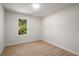 A minimal bedroom featuring light wood-look flooring and a view to the outdoors at 5541 Downs Way, Lithonia, GA 30058