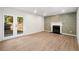 Living room featuring a decorative accent wall, fireplace, and french doors to the exterior at 5541 Downs Way, Lithonia, GA 30058