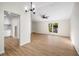 Open-concept living space with hardwood floors, large windows, and kitchen access at 5541 Downs Way, Lithonia, GA 30058