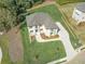 Aerial view of a luxurious house with a well-manicured lawn and a winding driveway at 3312 Steeple Chase Sw Way, Conyers, GA 30094