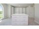 Bright walk-in closet with built-in shelving, island, and lots of storage space with a large window at 3312 Steeple Chase Sw Way, Conyers, GA 30094