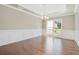 Elegant dining room featuring hardwood floors, wainscoting, and modern chandelier at 3312 Steeple Chase Sw Way, Conyers, GA 30094