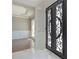 Elegant entryway with decorative iron double doors, hardwood floors and decorative trim and molding at 3312 Steeple Chase Sw Way, Conyers, GA 30094
