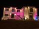 Festive two-story home adorned with colorful holiday lights and decorations at 3312 Steeple Chase Sw Way, Conyers, GA 30094