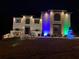 Festive two-story home adorned with colorful holiday lights and decorations at 3312 Steeple Chase Sw Way, Conyers, GA 30094