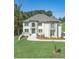 Stately two-story home with a manicured lawn and elegant architectural details at 3312 Steeple Chase Sw Way, Conyers, GA 30094