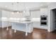 Bright kitchen featuring white cabinets, a marble island, and stainless steel appliances at 3312 Steeple Chase Sw Way, Conyers, GA 30094