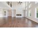 Open-concept living room with tall ceilings, fireplace and plenty of windows at 3312 Steeple Chase Sw Way, Conyers, GA 30094