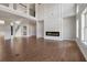 Spacious open-concept living room with a fireplace, hardwood floors, and lots of natural light from large windows at 3312 Steeple Chase Sw Way, Conyers, GA 30094