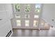 Bright living room with a soaring ceiling, large windows, a ceiling fan, and a view of the entry and fireplace at 3312 Steeple Chase Sw Way, Conyers, GA 30094