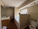 Bathroom featuring a large mirror, double vanity, bath tub, and a window for natural light at 430 N Oakland Cir, Mcdonough, GA 30253