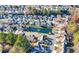 An aerial view of a neighborhood with a pond and fountain surrounded by well-maintained homes and mature trees at 1920 Rosebriar Dr, Marietta, GA 30066
