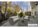 Outdoor patio featuring cushioned wicker furniture and a view of the fenced backyard and surrounding trees at 1920 Rosebriar Dr, Marietta, GA 30066
