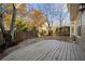 A wooden deck with a stone patio overlooks the fence-enclosed backyard area at 1920 Rosebriar Dr, Marietta, GA 30066