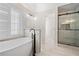 Bright bathroom featuring a standalone tub, tiled shower, and modern fixtures at 1920 Rosebriar Dr, Marietta, GA 30066