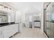Bright bathroom featuring dual vanities, a standalone tub, and a glass enclosed shower at 1920 Rosebriar Dr, Marietta, GA 30066