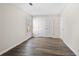 Neutral bedroom featuring wood floors, a window, and a double door closet at 1920 Rosebriar Dr, Marietta, GA 30066