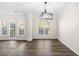 Dining area featuring modern light fixture, elegant columns, and large windows at 1920 Rosebriar Dr, Marietta, GA 30066