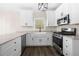 Updated kitchen with white cabinets, granite countertops, a stainless steel range, and hardwood flooring at 1920 Rosebriar Dr, Marietta, GA 30066
