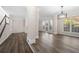 Bright open-concept living room with hardwood floors, neutral tones, and elegant lighting fixture at 1920 Rosebriar Dr, Marietta, GA 30066