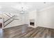 Spacious living room with hardwood floors, fireplace and staircase with black banister at 1920 Rosebriar Dr, Marietta, GA 30066