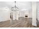 Open-concept living area featuring hardwood floors, a fireplace, and modern light fixtures at 1920 Rosebriar Dr, Marietta, GA 30066