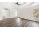 Main bedroom with tray ceiling, ceiling fan, hardwood floors, and large windows at 1920 Rosebriar Dr, Marietta, GA 30066