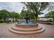 Brick fountain surrounded by benches and mature shade trees, creating a welcoming park atmosphere at 1920 Rosebriar Dr, Marietta, GA 30066
