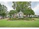 Green park gazebo surrounded by green grass and mature trees in a park in a suburban neighborhood at 1920 Rosebriar Dr, Marietta, GA 30066