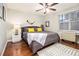 Comfortable bedroom with hardwood floors, a queen-sized bed, a ceiling fan, and a city view from the window at 300 W Peachtree St # 21K, Atlanta, GA 30305
