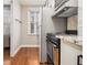Practical kitchen featuring white cabinets, stainless steel appliances, and hardwood floors for a functional space at 300 W Peachtree St # 21K, Atlanta, GA 30305