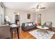 Cozy living room with hardwood floors, a dining table, and an open view into the kitchen area at 300 W Peachtree St # 21K, Atlanta, GA 30305