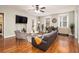 Inviting living room featuring hardwood floors, a comfortable sofa, a ceiling fan, and an adjacent dining area at 300 W Peachtree St # 21K, Atlanta, GA 30305