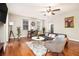 Relaxing living room featuring hardwood floors, modern furniture, natural light from windows, and a ceiling fan at 300 W Peachtree St # 21K, Atlanta, GA 30305